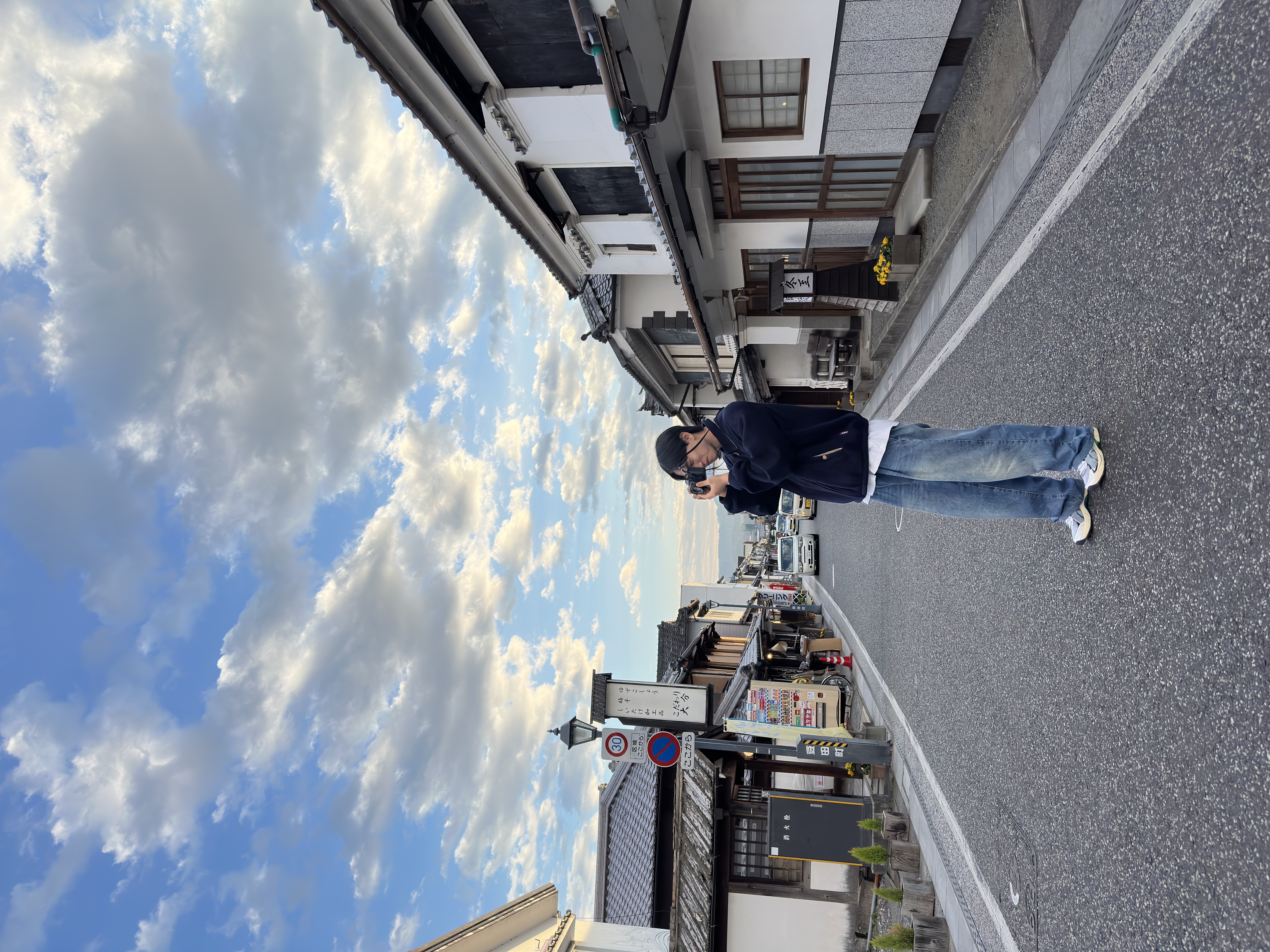 Juwon Park taking a photo on a quiet street
